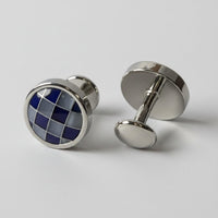 Cufflinks with blue and silver design on a white background