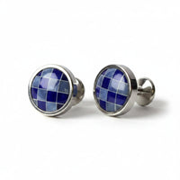 Pair of cufflinks with blue gemstones on a white background