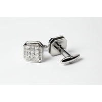 Pair of silver cufflinks with one featuring clear gemstones on a light gray background