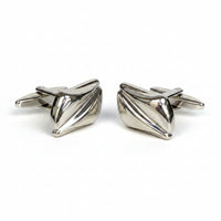 Pair of silver bow-shaped cufflinks on a white background