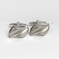 Pair of silver cufflinks on a white background