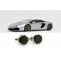 Hexagonal cufflinks with green and black pattern on a white background