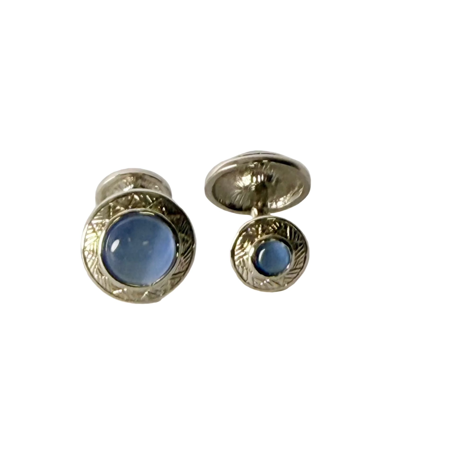 Pair of silver cufflinks with blue stones on a white background