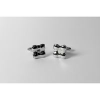 Silver square-shaped cufflinks on a silver background