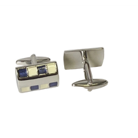 Pair of silver cufflinks with blue and white square design on a light gray background