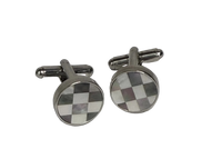 A pair of round silver-toned cufflinks with a checkered pattern in brown, white, and gray mother-of-pearl inlay, displayed on a light gray background.
