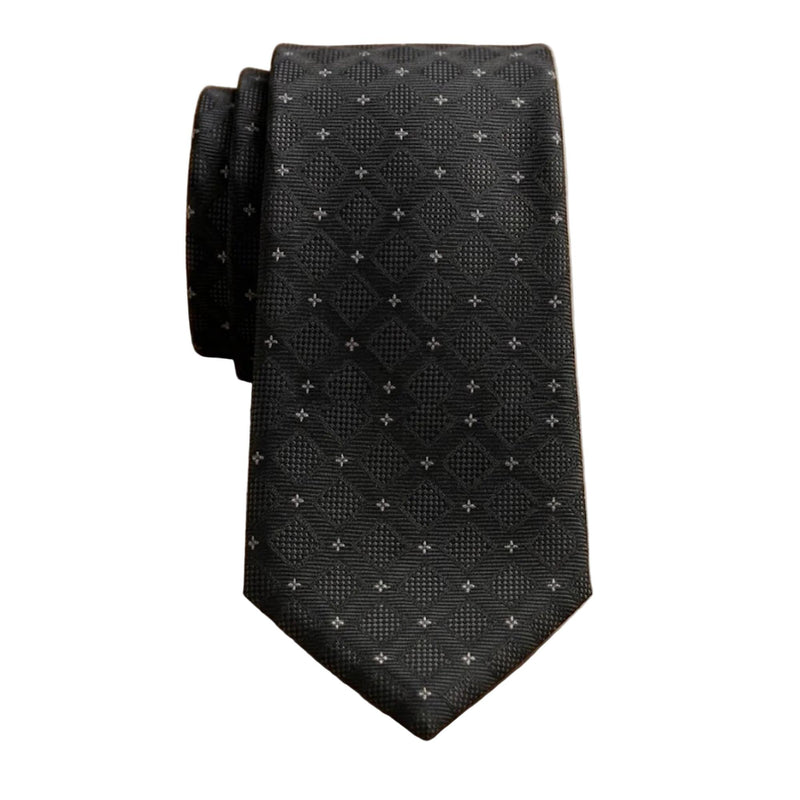 A black textured necktie with a small white geometric pattern, folded on a light wood grain surface.