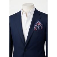 A navy blue suit jacket displayed on a cream mannequin torso, paired with a crisp white dress shirt and a patterned pocket square in navy, burgundy, and gold.
