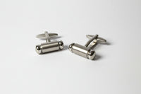 Pair of silver cufflinks on a white background