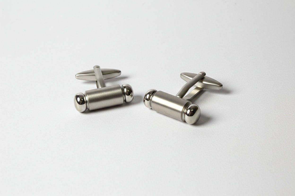 Pair of silver cufflinks on a white background