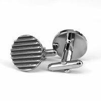 Pair of silver striped cufflinks on a white background