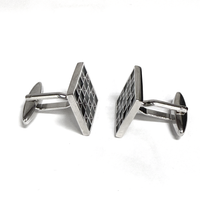 Silver geometric cufflinks on a white background