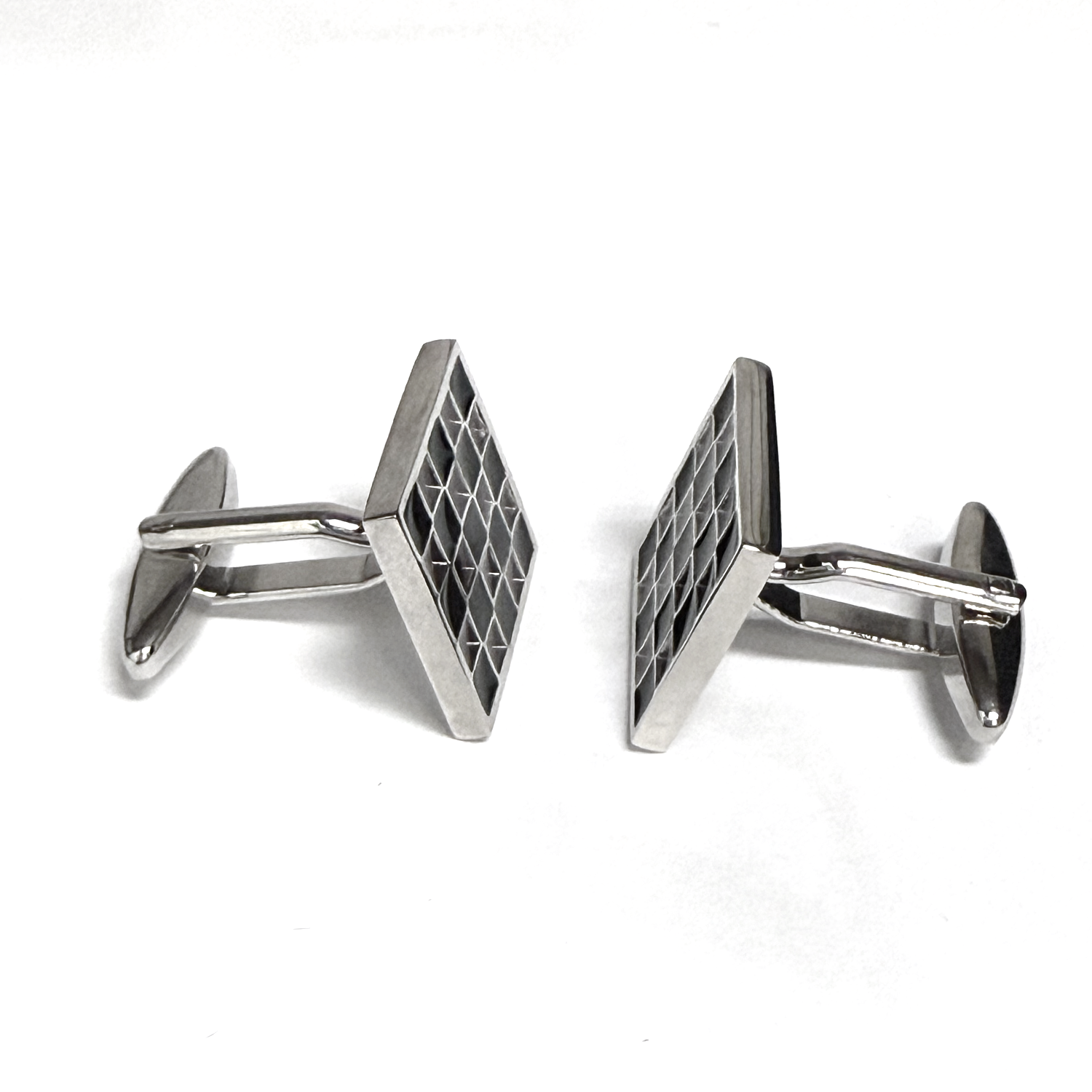 Silver geometric cufflinks on a white background